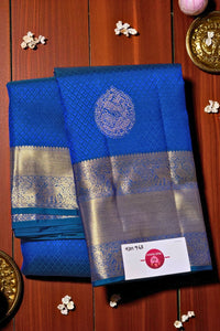 Blue saree with silver border on a wooden background