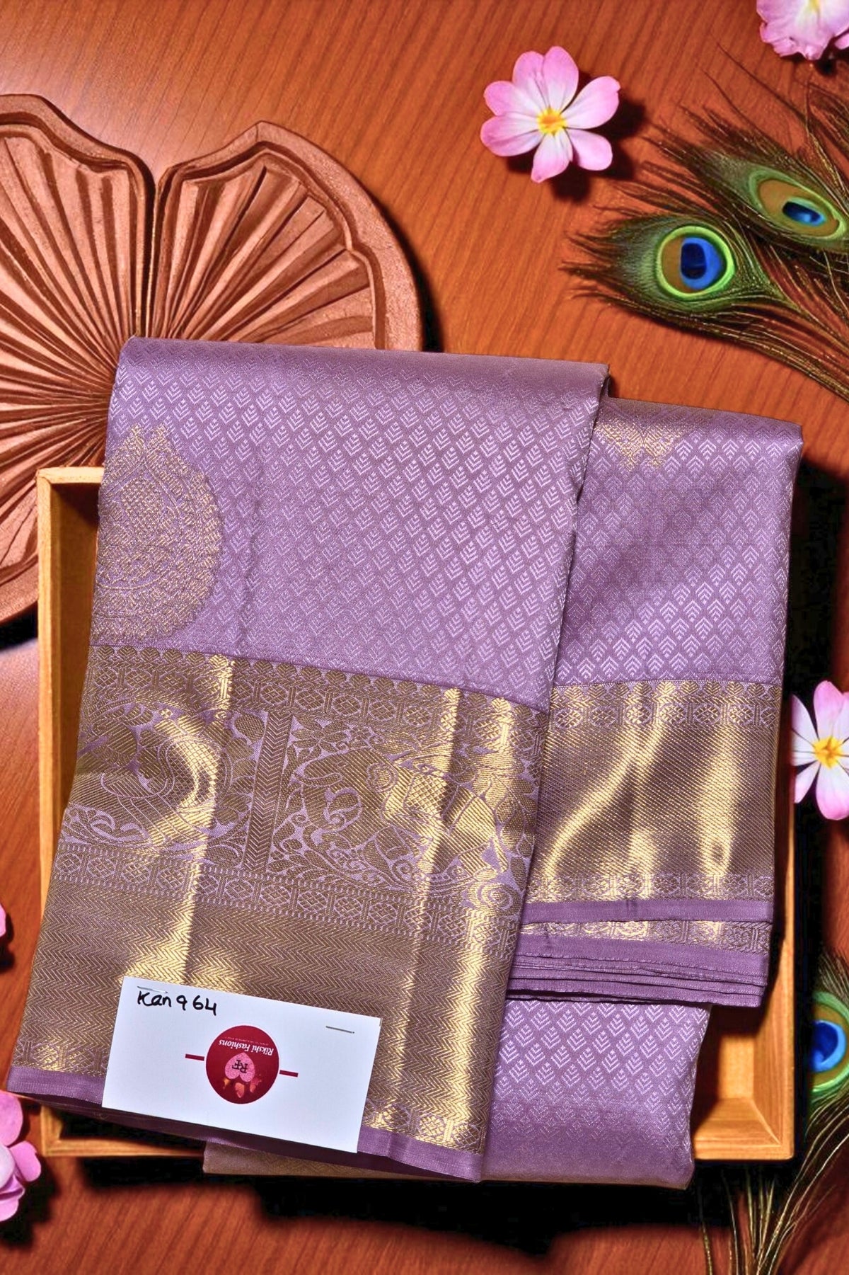 Purple and gold fabric with a brand label on a wooden surface with decorative elements.