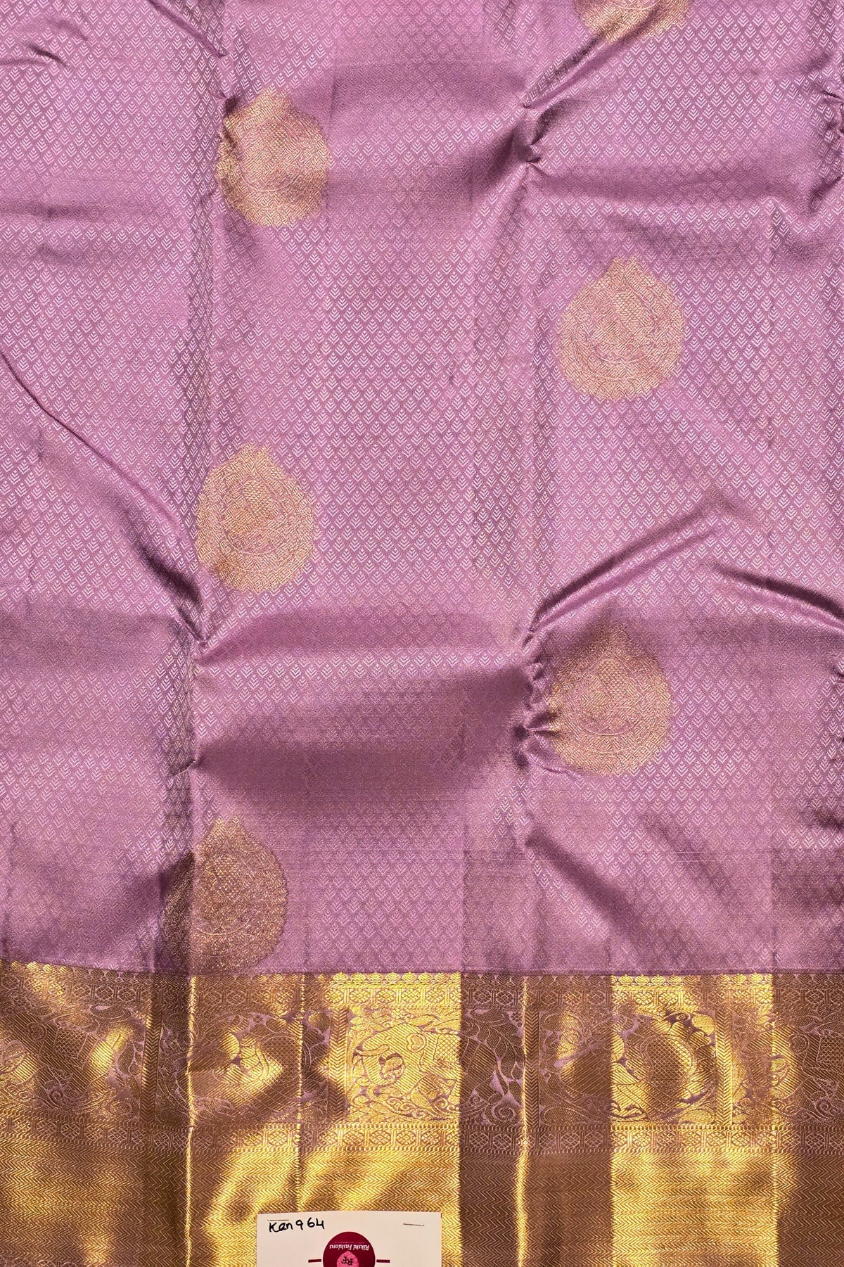 Purple fabric with gold circular patterns