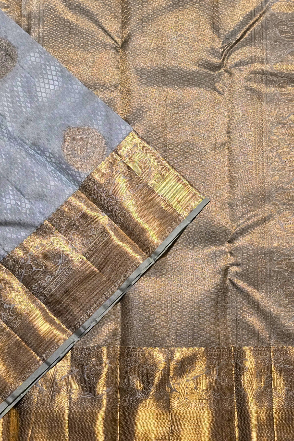 Close-up of a textured fabric with gold and brown patterns