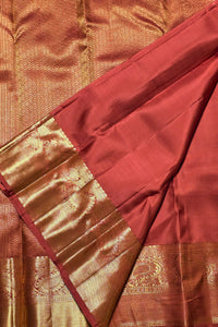 Close-up of a red and gold saree with intricate patterns