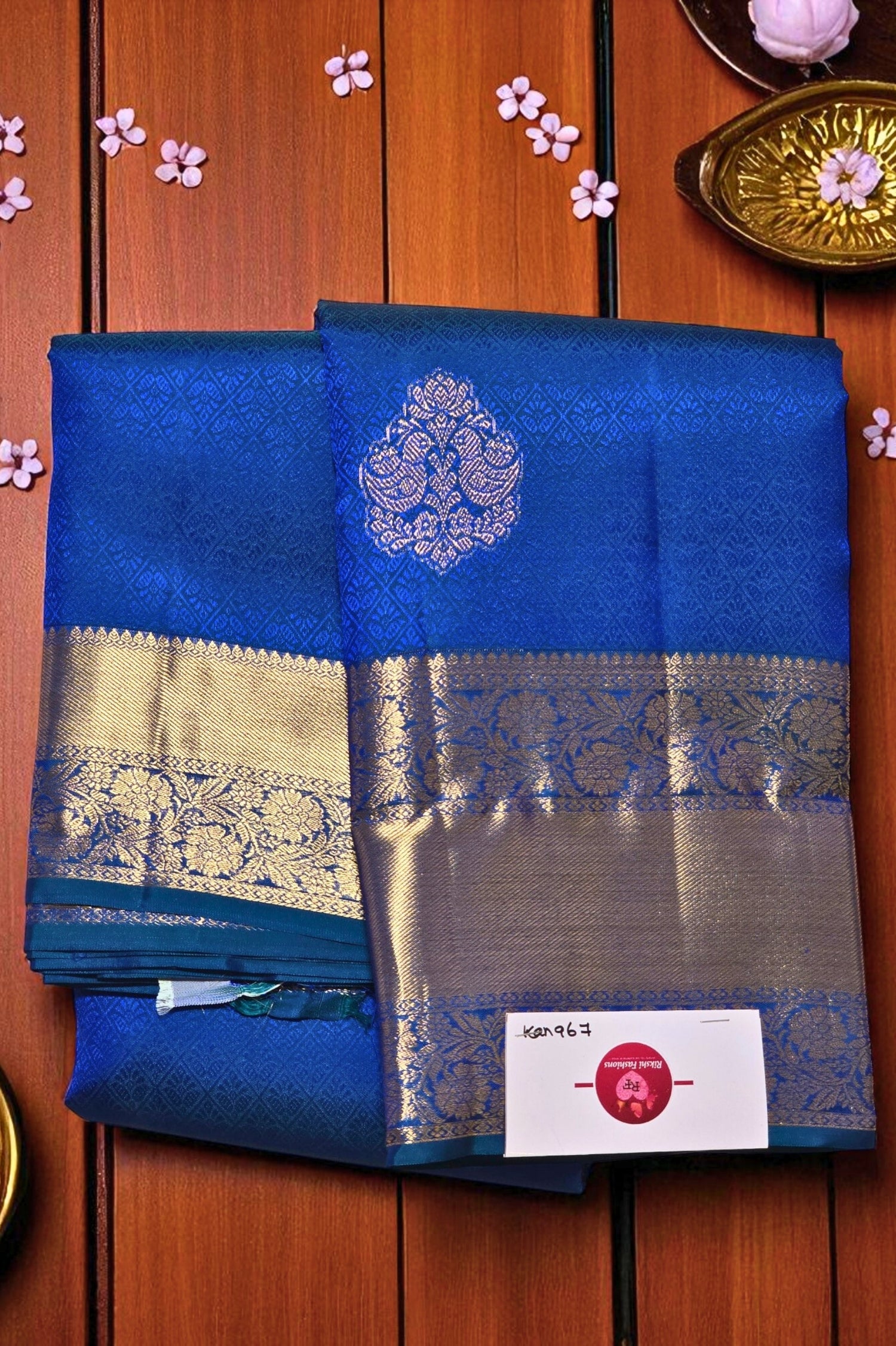 Blue saree with silver border on a wooden background
