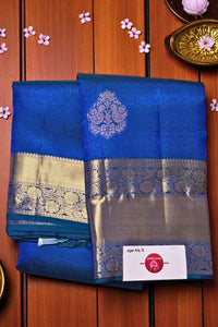 Blue saree with silver border on a wooden background