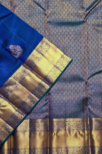 Close-up of a blue and gold saree with intricate patterns