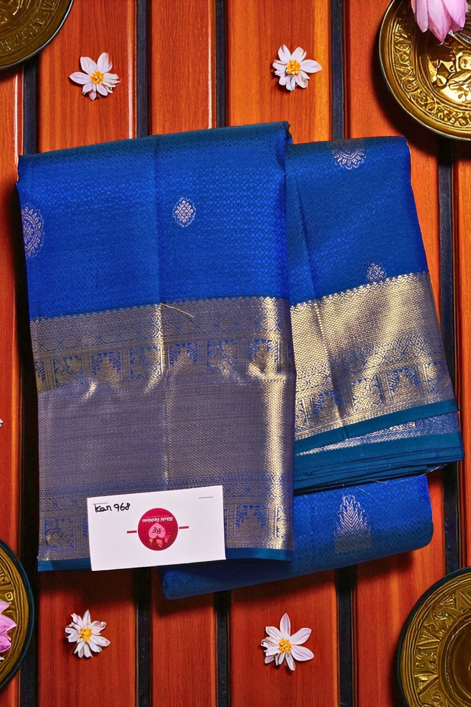 Blue and silver saree with a brand label on a wooden background
