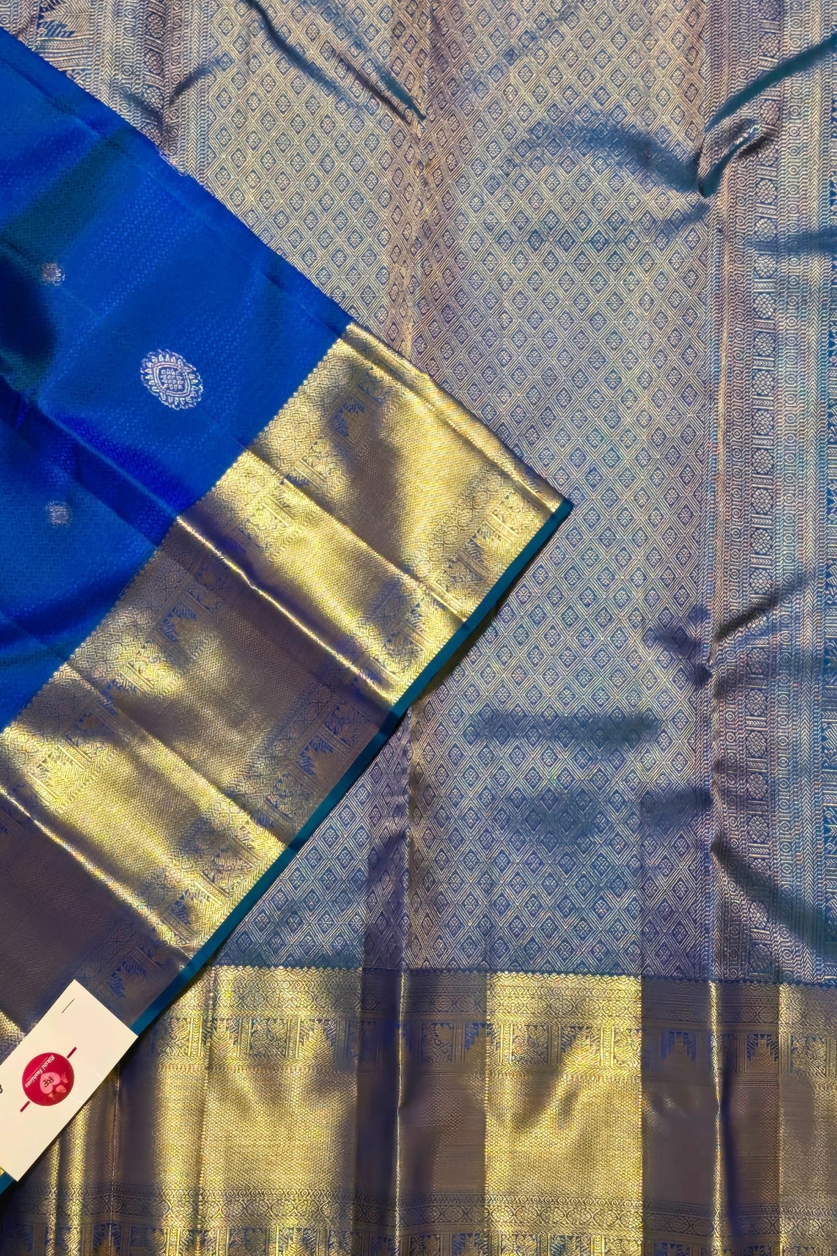 Blue and gold saree with a visible brand label