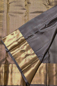Close-up of a traditional fabric with gold and black patterns