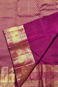Purple saree with gold border on a matching fabric background