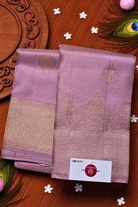 Two pink sarees with gold border on a wooden background