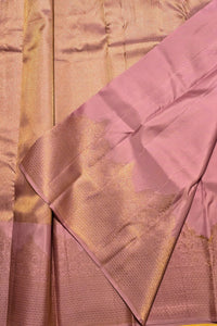 Close-up of a pink saree with a gold border