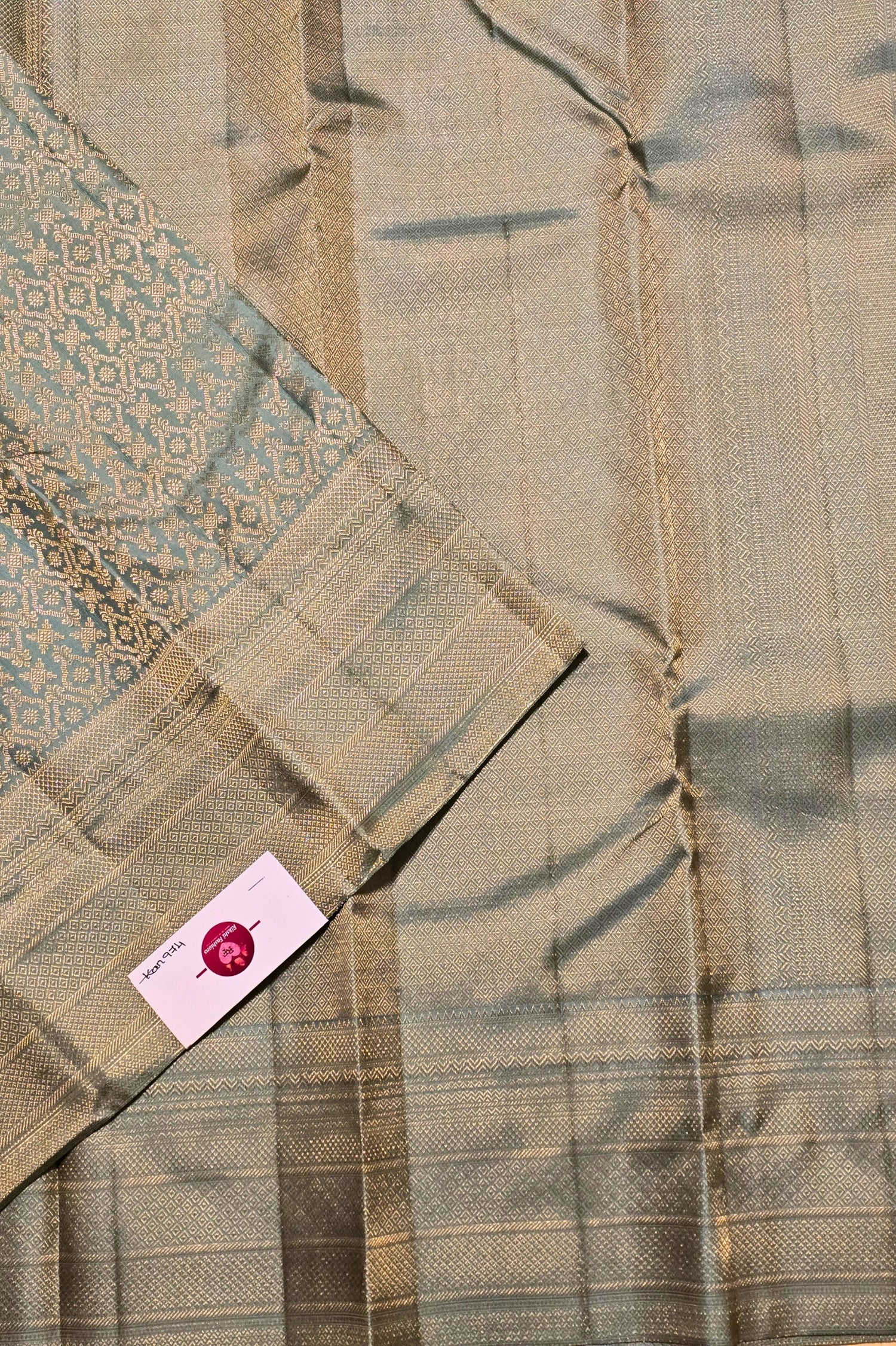 Close-up of a fabric with a patterned tag on a textured background