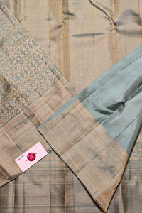 Close-up of a quilt with geometric patterns and a brand label.