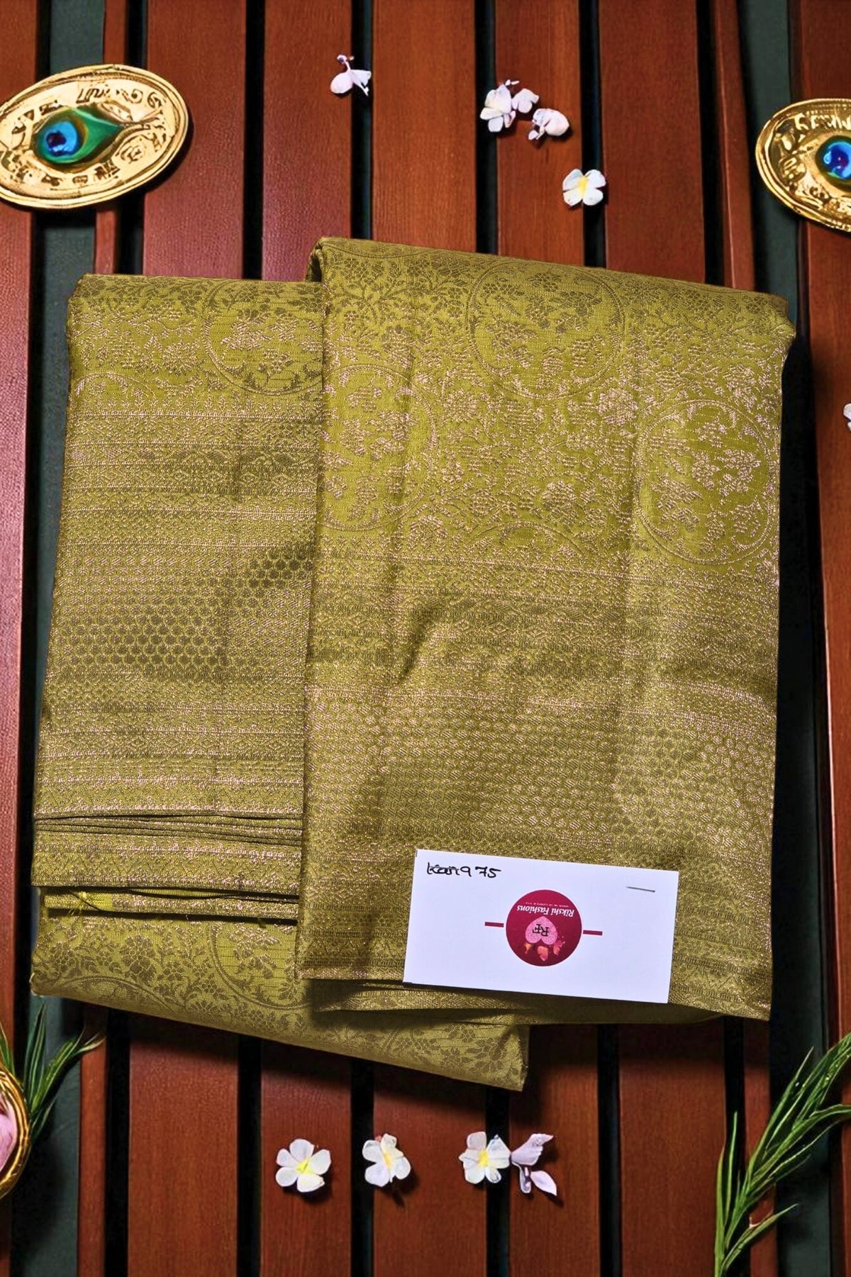 Two green patterned cloths with a brand label on a wooden background