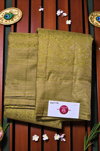 Two green patterned cloths with a brand label on a wooden background
