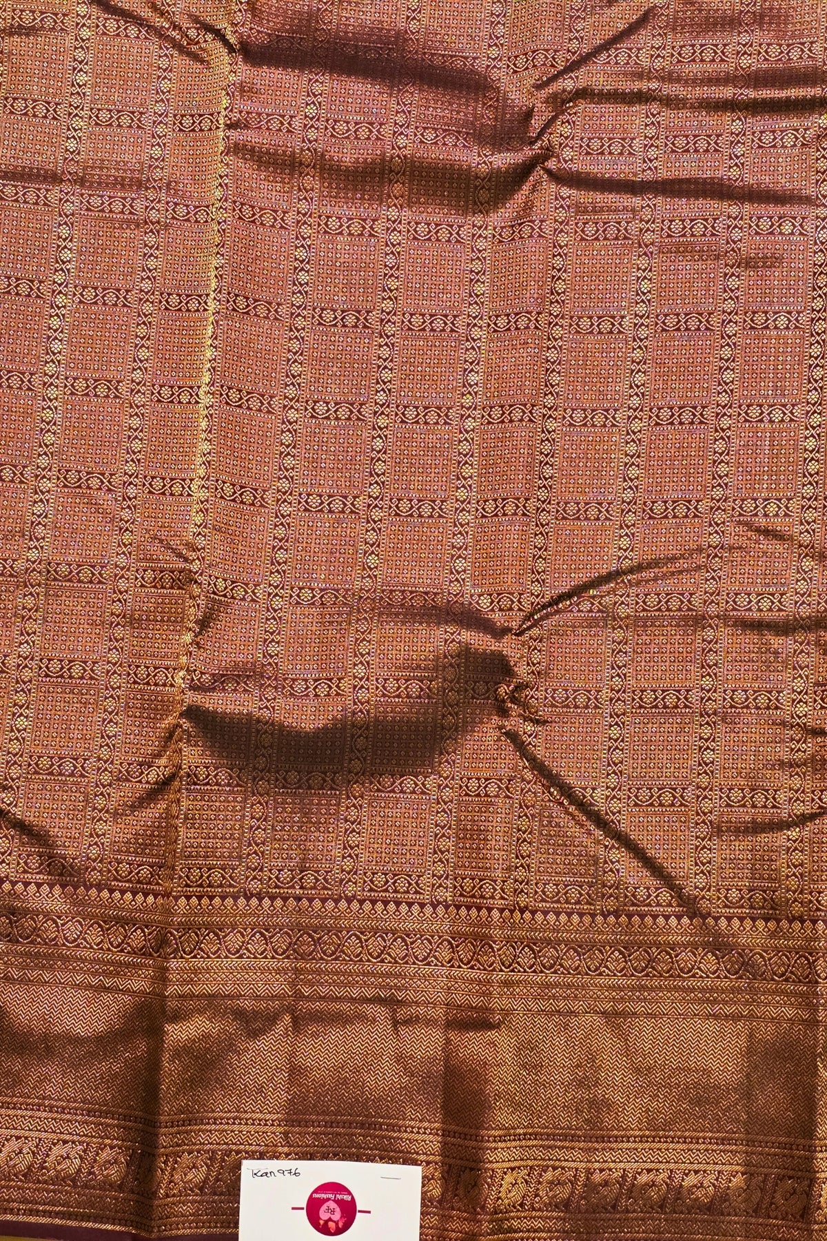 Brown fabric with intricate pattern and visible tag