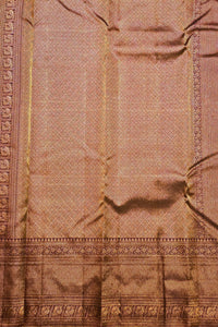Close-up of a pink fabric with intricate patterns and embroidery