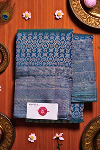 Blue patterned fabric with a brand label on a wooden surface