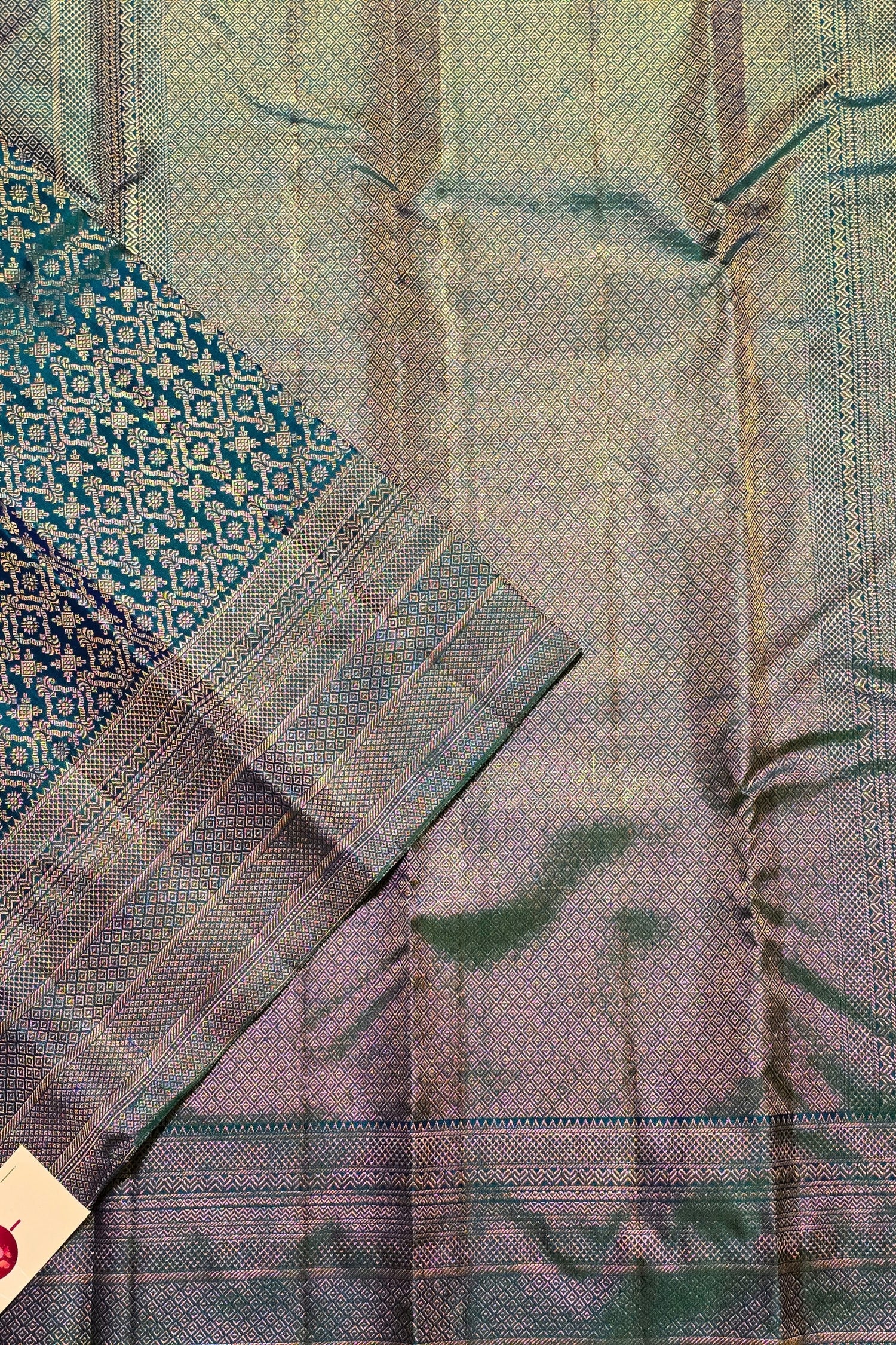 Close-up of a fabric with a patterned border and plain background