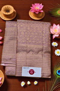 Stack of brown fabric with a brand label on a wooden surface with decorative elements.