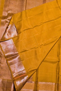 Close-up of a yellow fabric with a metallic border