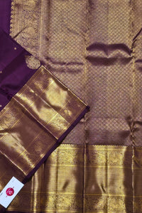 Close-up of a purple and gold saree with intricate patterns