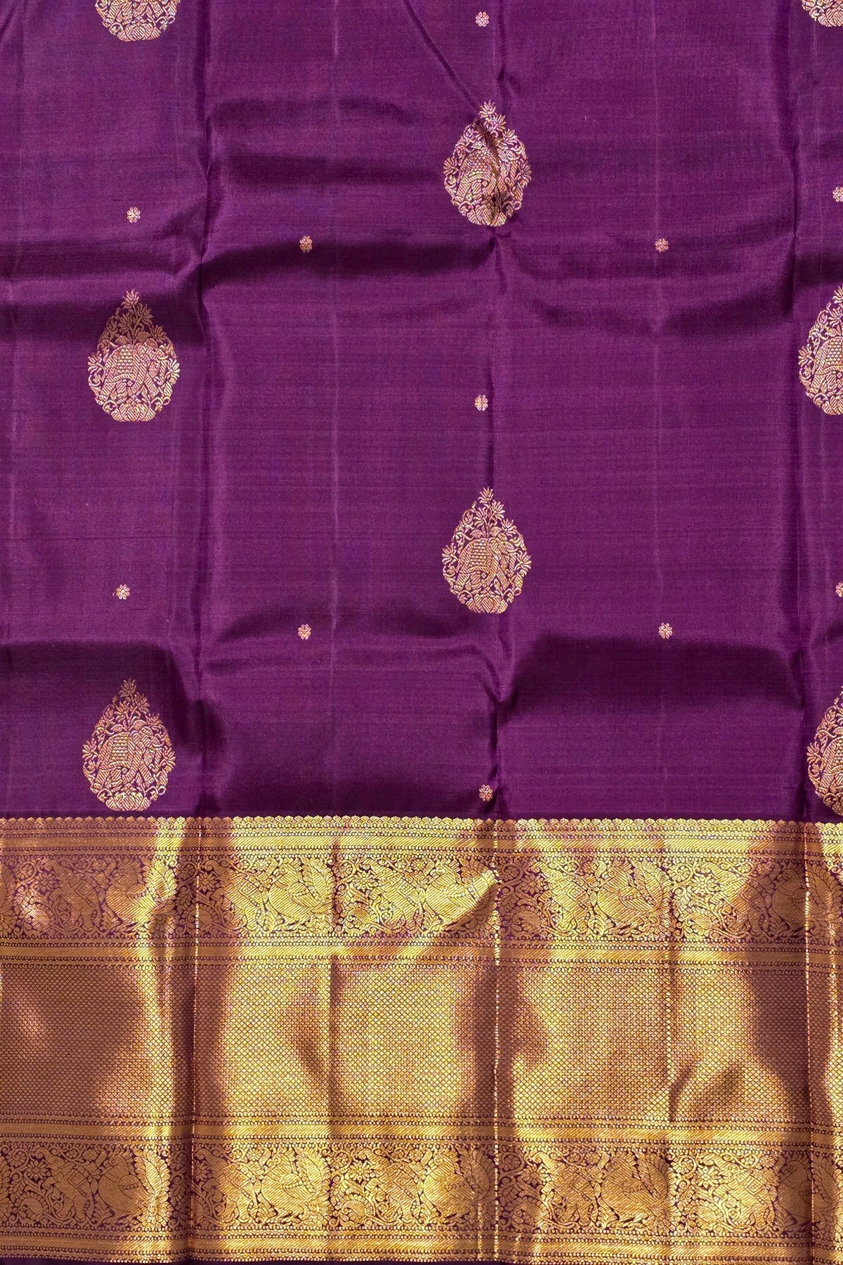 Purple fabric with gold patterns and border