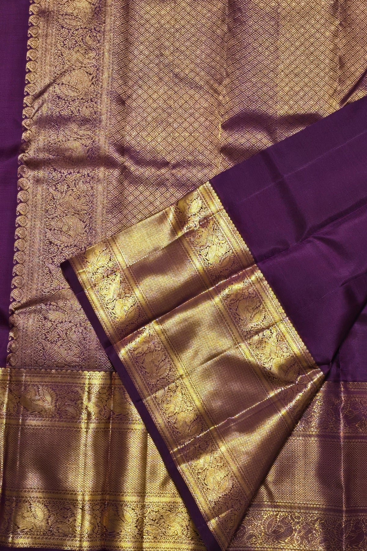 Purple and gold saree with intricate patterns