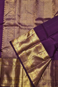 Purple and gold saree with intricate patterns