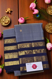 Blue saree with gold stripes on a wooden background with decorative elements