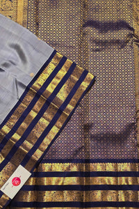 Traditional saree with gold and blue patterns on a textured background