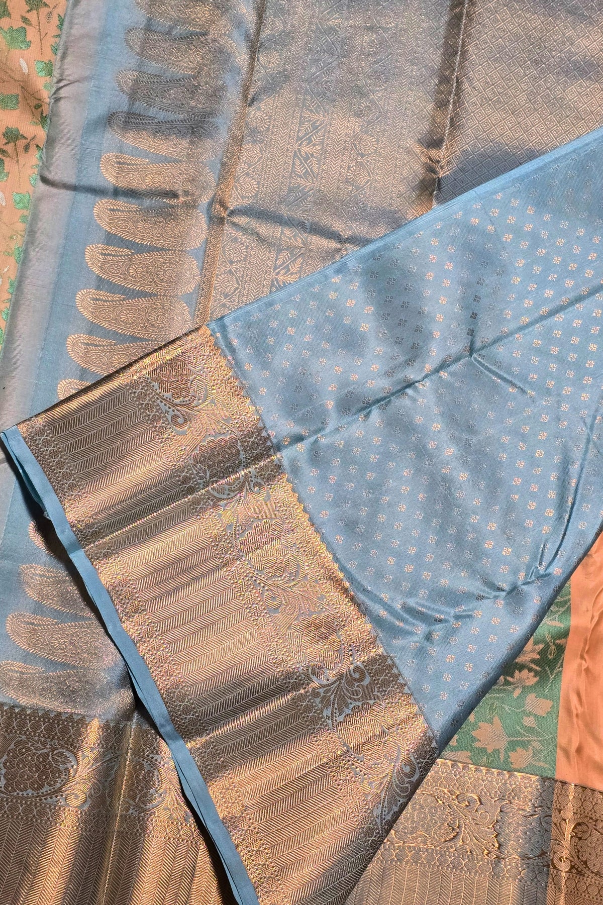 Close-up of a traditional saree with blue and brown patterns