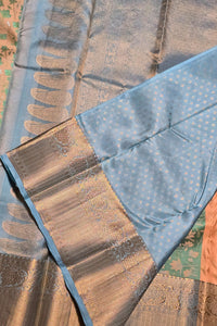 Close-up of a traditional saree with blue and brown patterns