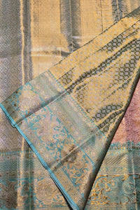 Close-up of a patterned fabric with blue, green, and beige colors.