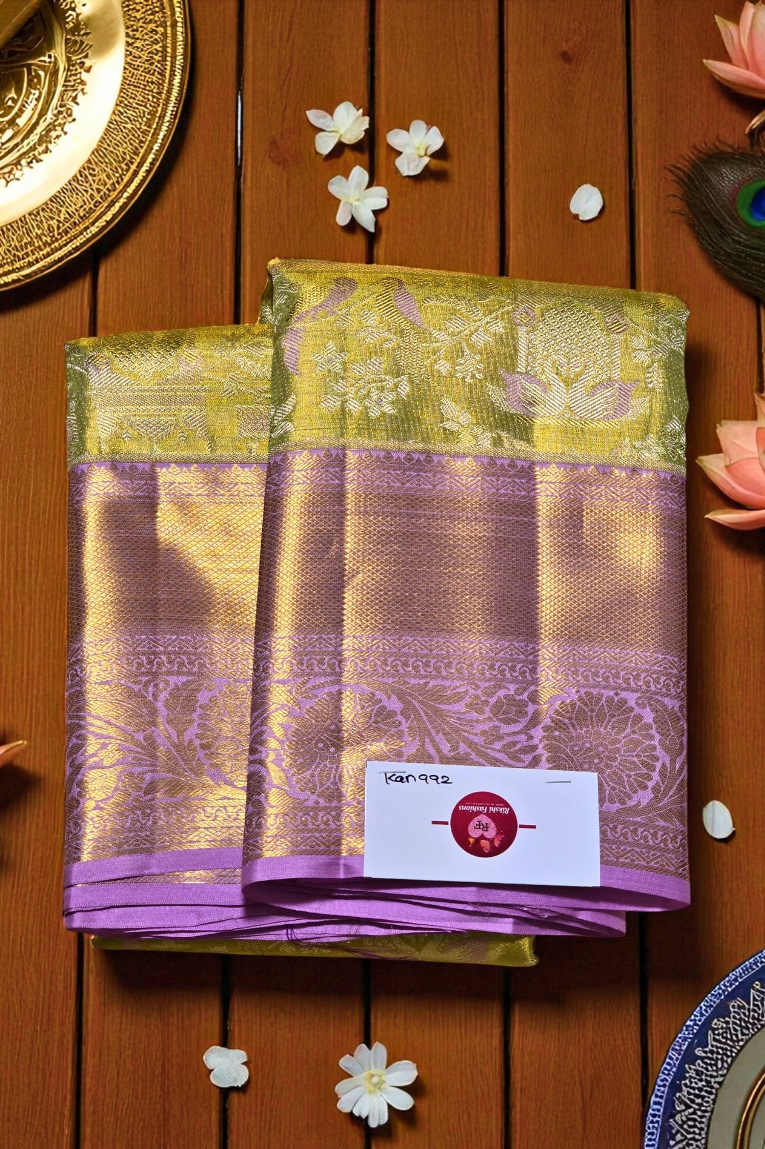 Purple and green saree with a brand label on a wooden background