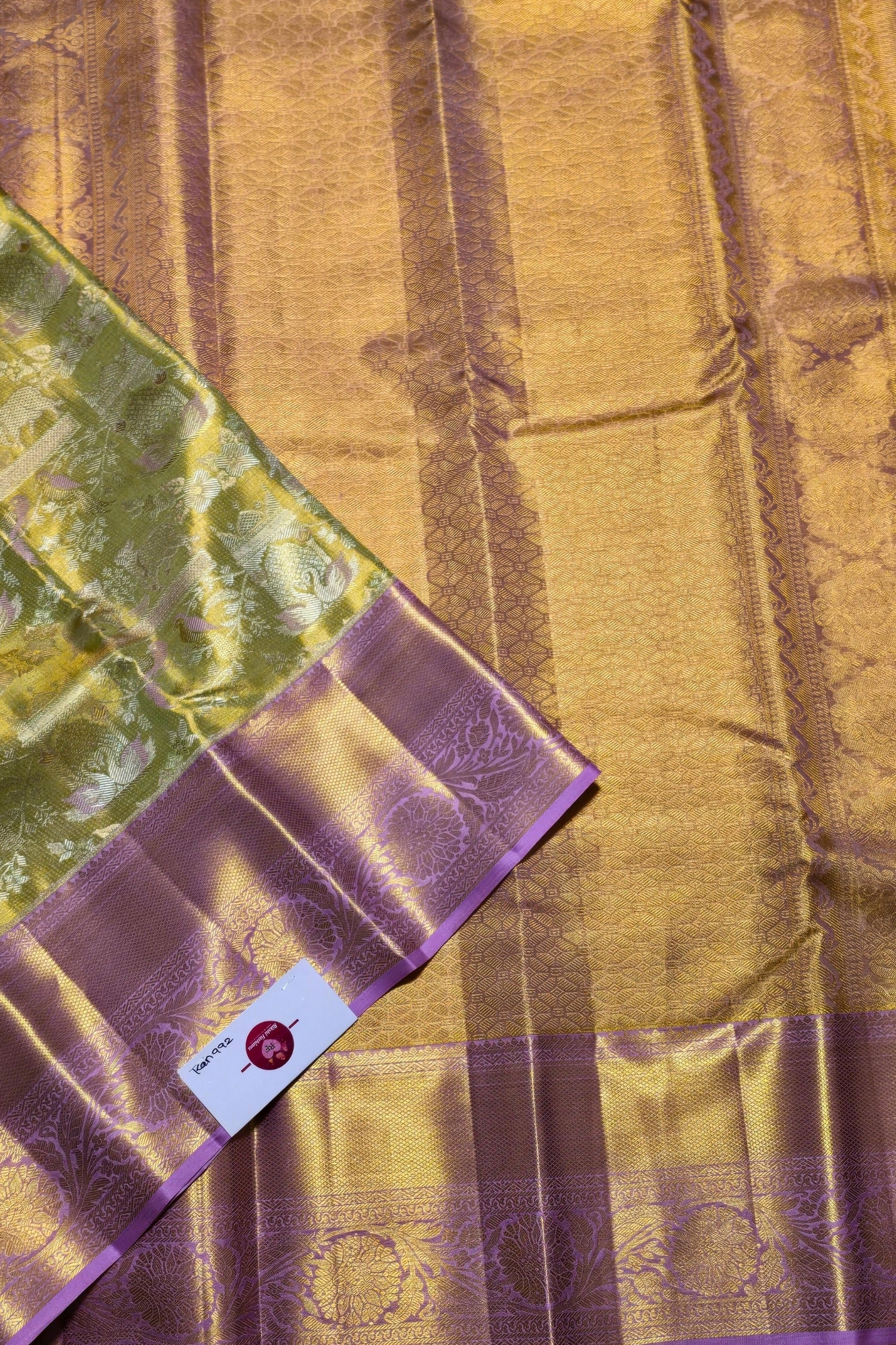 Purple and gold fabric with a visible brand label