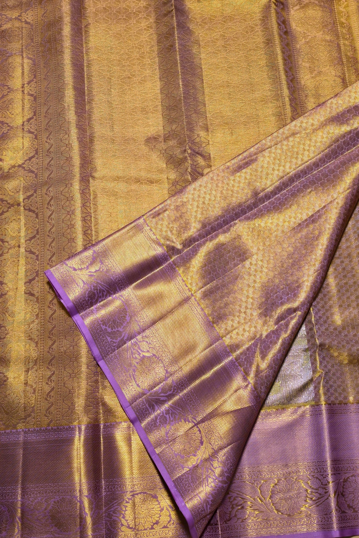 Close-up of a fabric with gold and purple pattern