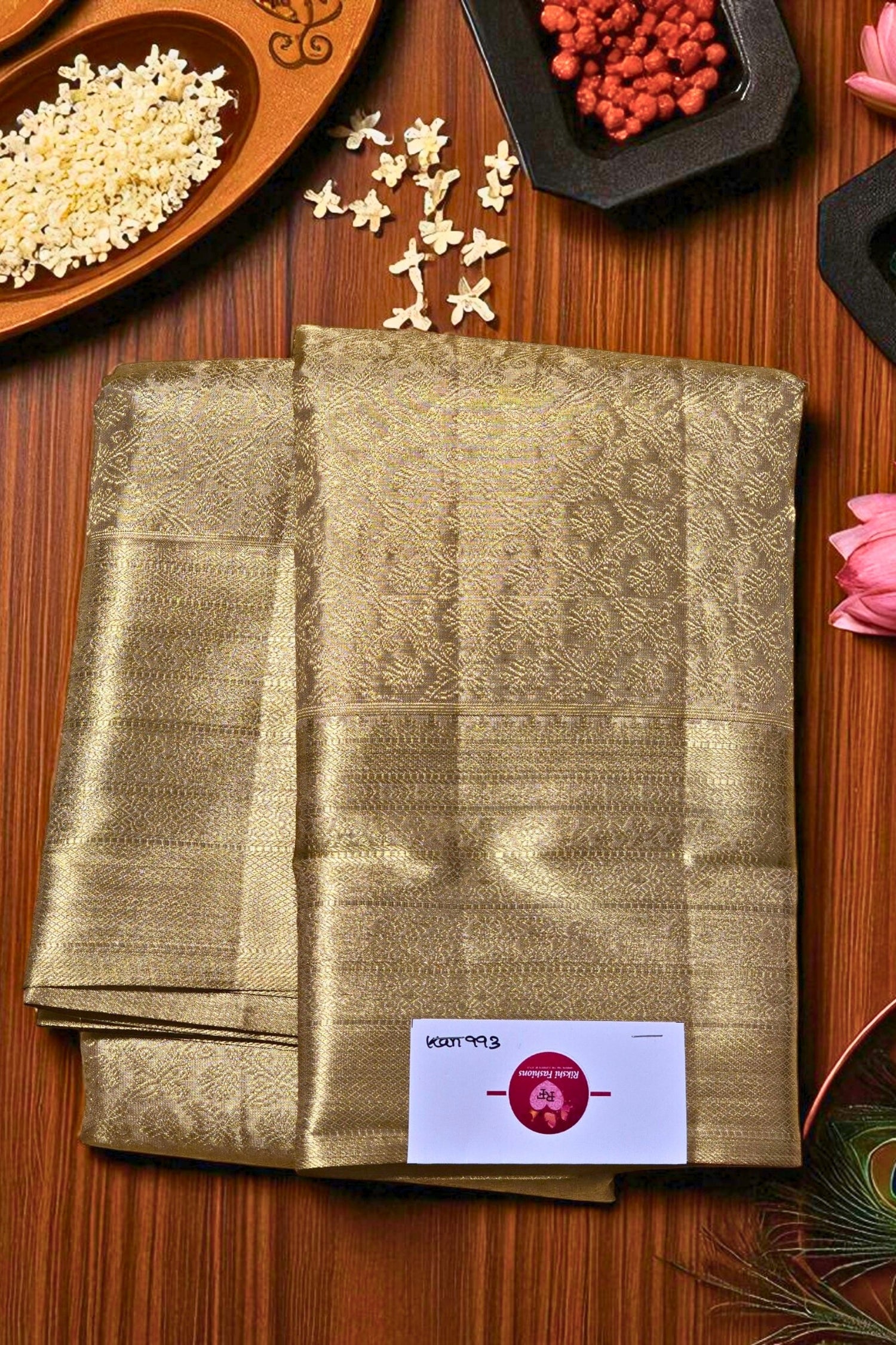 Folded fabric with a brand label on a wooden surface with decorative items.