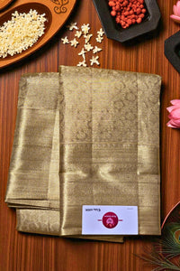 Folded fabric with a brand label on a wooden surface with decorative items.