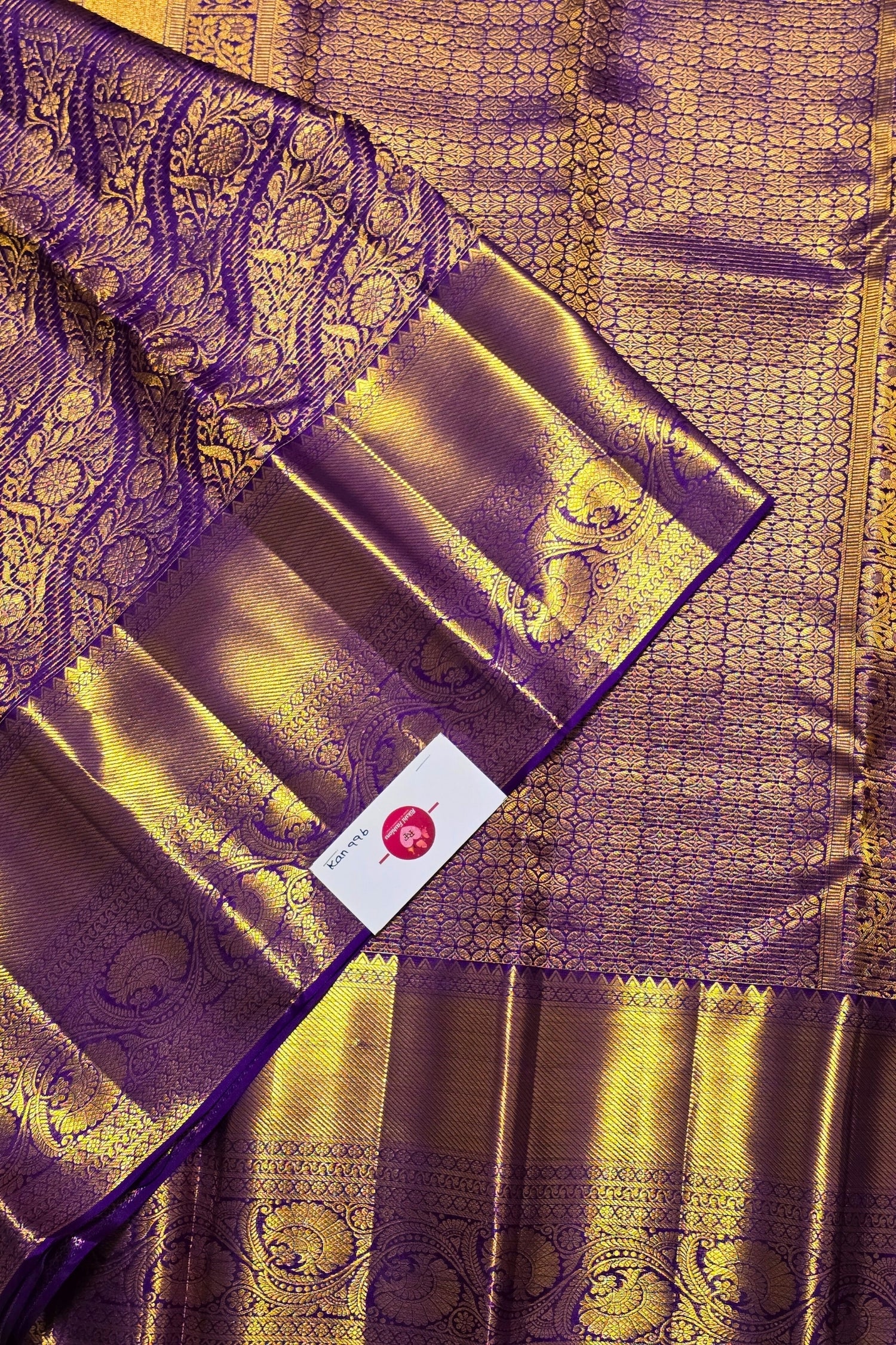 Purple and gold traditional fabric with intricate patterns