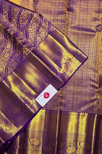 Purple and gold traditional fabric with intricate patterns
