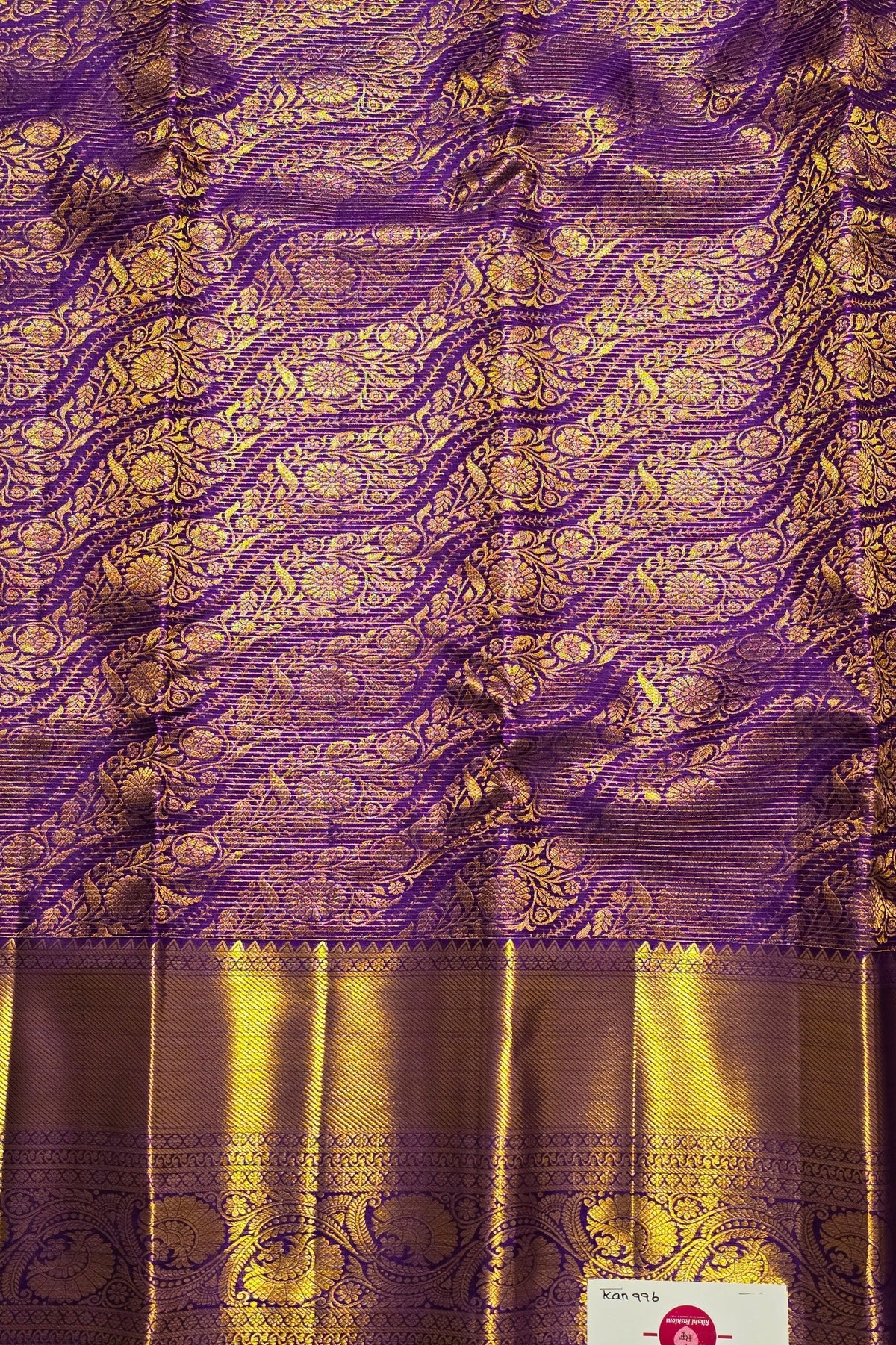 Purple and gold traditional fabric with intricate patterns