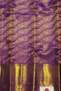 Purple and gold traditional fabric with intricate patterns