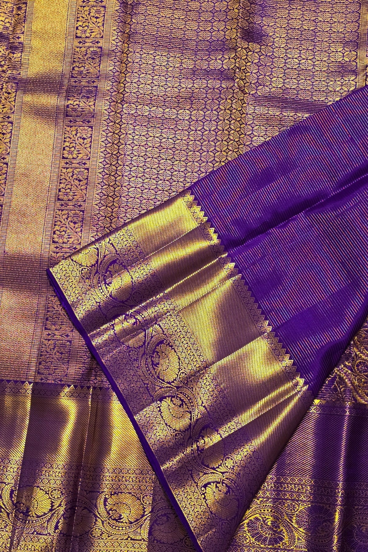 Purple and gold traditional fabric with intricate patterns