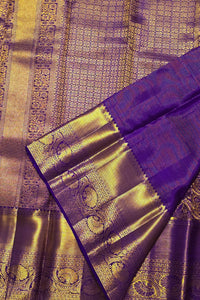 Purple and gold traditional fabric with intricate patterns