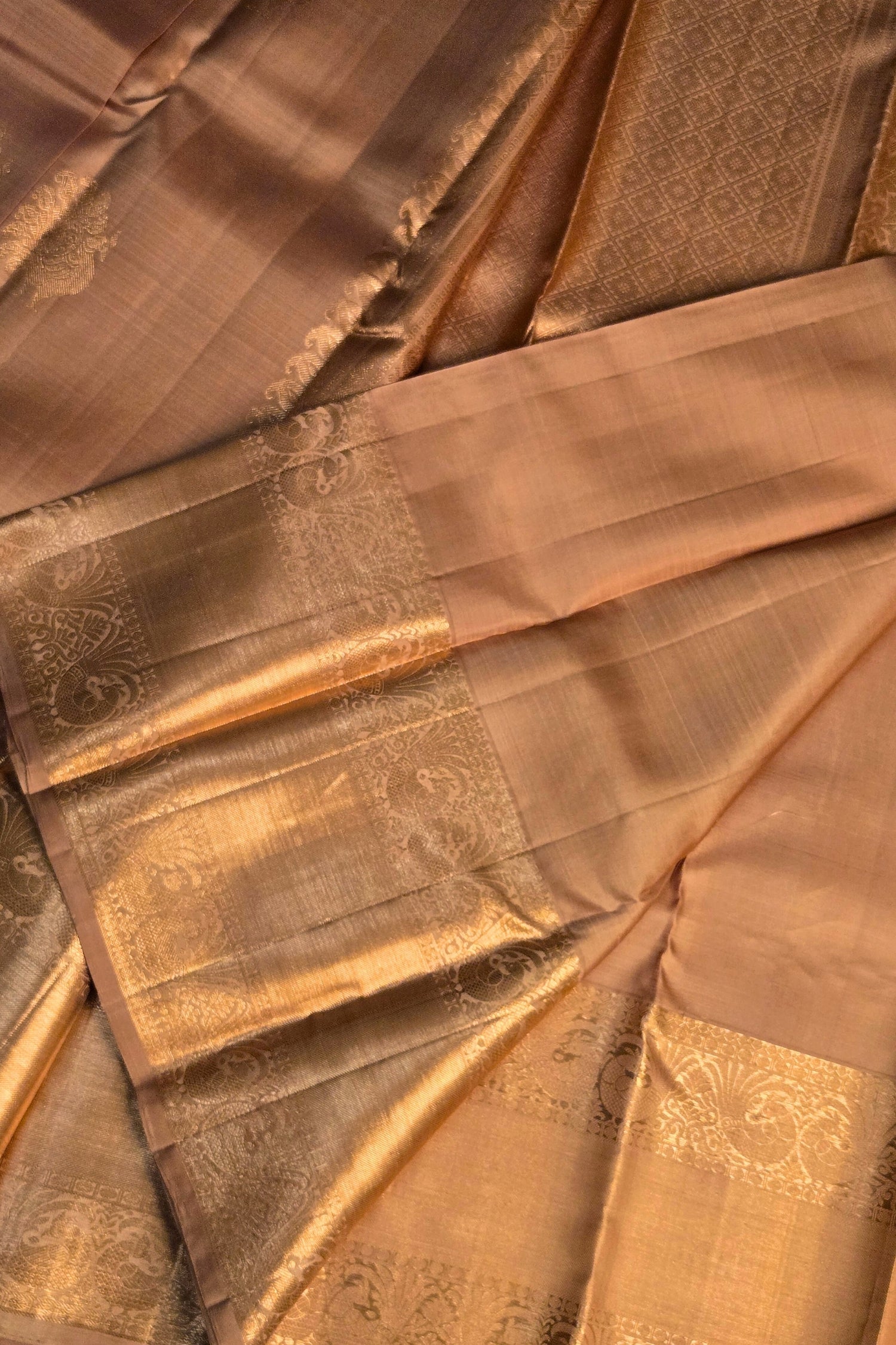 Close-up of golden zari work on yellow silk fabric