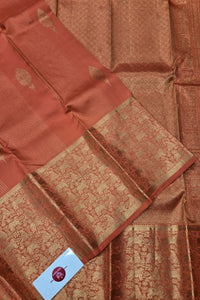 Brown saree with a patterned border on a matching fabric background