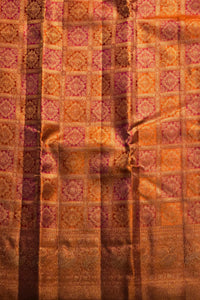 Patterned fabric with a checkered design in shades of brown, orange, and purple.