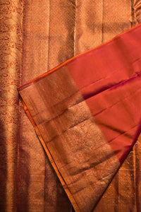 Close-up of a red and gold saree with intricate patterns.