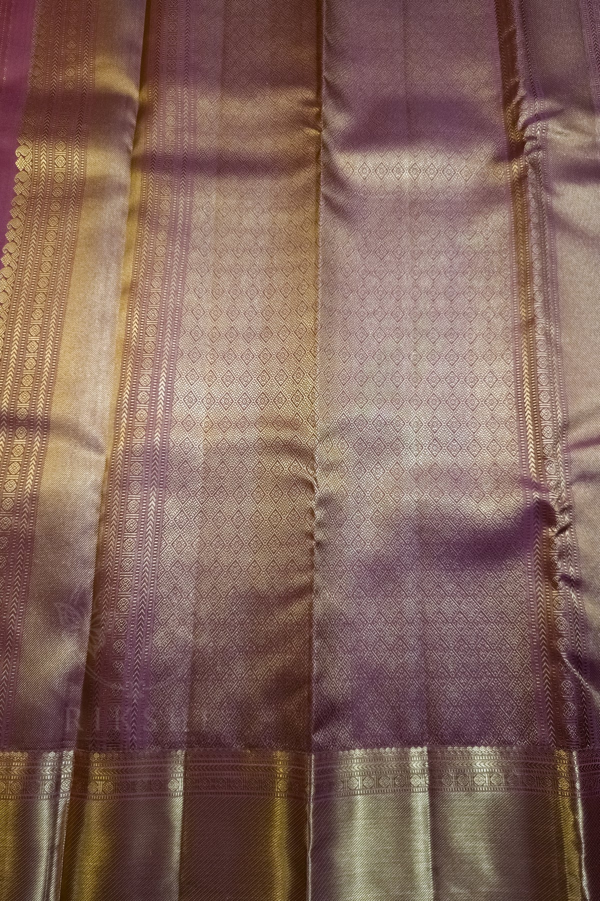 Royal Purple Silk Saree with Wide Gold Zari Border showing elegant fabric texture and shimmering patterns.