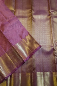 Royal Purple Silk Saree with Wide Gold Zari Border folded elegantly with a shimmering gold border.